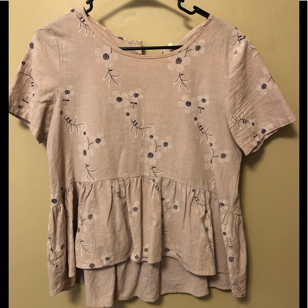 Pink blouse with flowers.